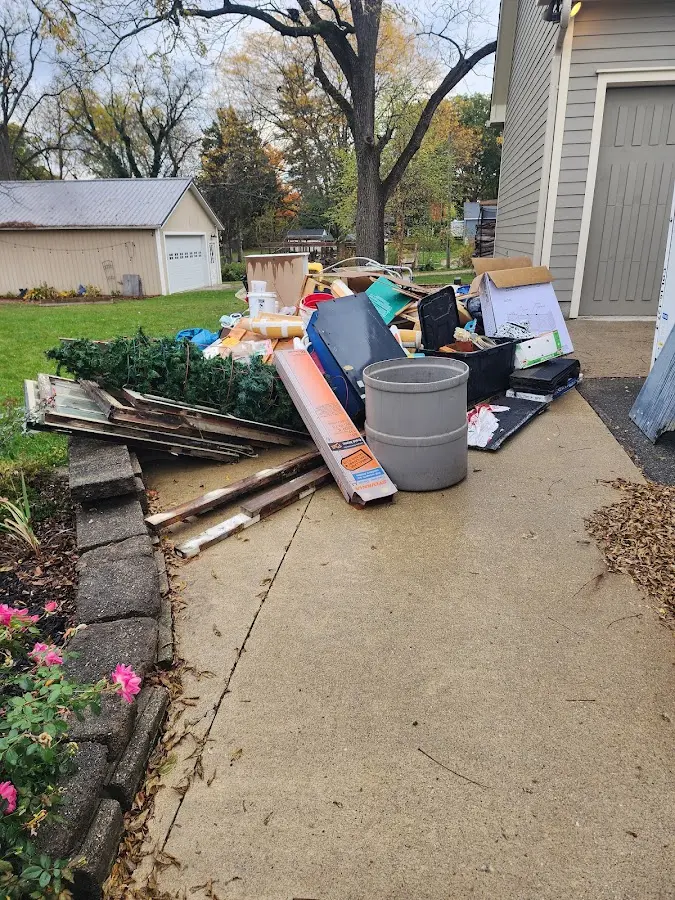 Dumpster being loaded with debris for Commercial Dumpster Rental in Robertsdale
